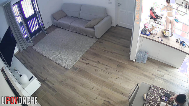 A slim brunette in seductive white lingerie is cleaning her apartment
