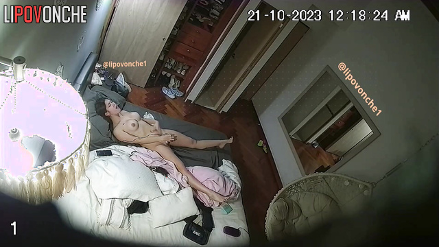 Skinny brunette with big tits masturbates in front of the mirror on the bed