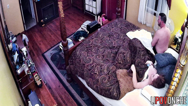 A redheaded cutie with bare breasts gets into bed with her husband