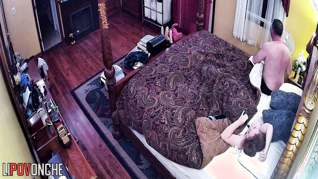 A redheaded cutie with bare breasts gets into bed with her husband