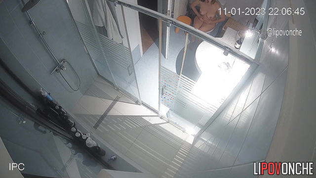 A sleepy woman, completely naked, walks into the toilet