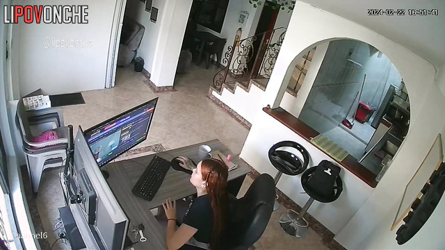 A bored redhead is browsing a porn chat room featuring seductive naked girls