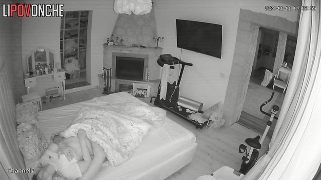 The husband playfully nibbles his wife's soft buttocks as he pulls down her panties