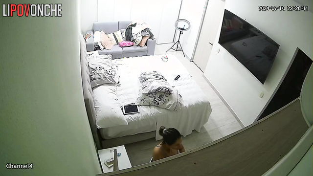 A cutie with a sexy ass seductively undresses while waiting for her lover