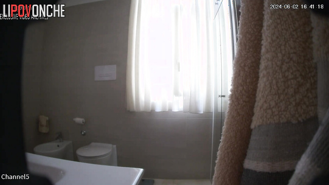 A strict teacher wearing glasses pees and tries on a new bra in the restroom