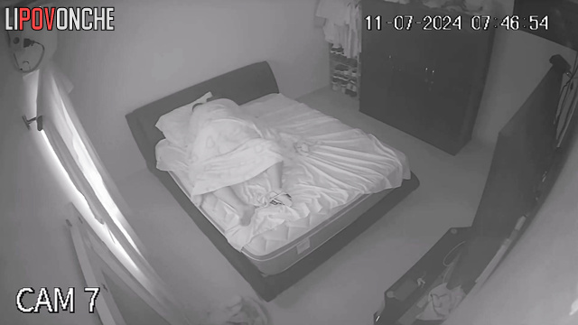 An aroused husband tries to press his cock against his sleeping wife's ass
