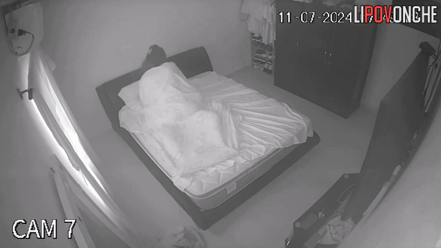 An aroused husband tries to press his cock against his sleeping wife's ass