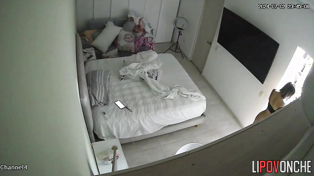 A gorgeous naked beauty with a curvaceous body is making the bed for the night