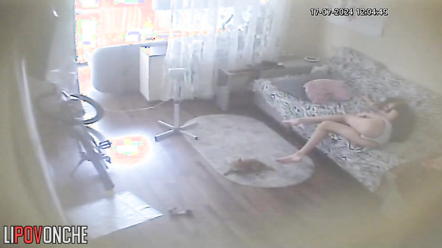Young brunette chilling alone on the sofa (with phone)