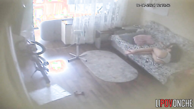 Young brunette chilling alone on the sofa (with phone)