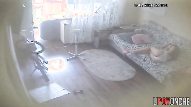 Young brunette chilling alone on the sofa (with phone)