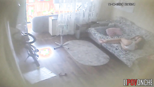 Young brunette chilling alone on the sofa (with phone)