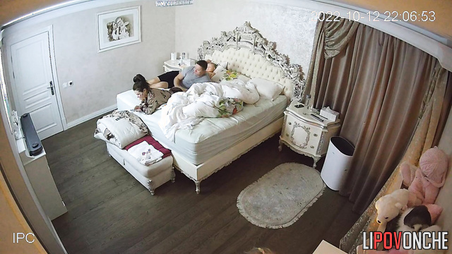 Close relatives are watching tv together (in the cozy bedroom)
