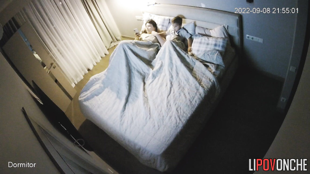 Chubby brunette hugging her small relative in the bed, hidden cam