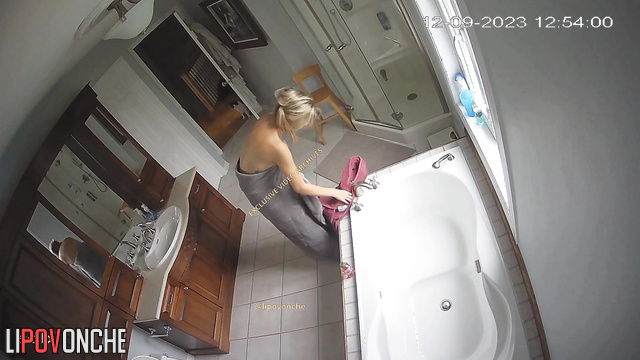 Young tattooed whore chatting with clients in the bathtub