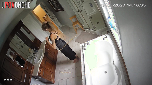 Young slut shaking her ass on camera in an elegant dress
