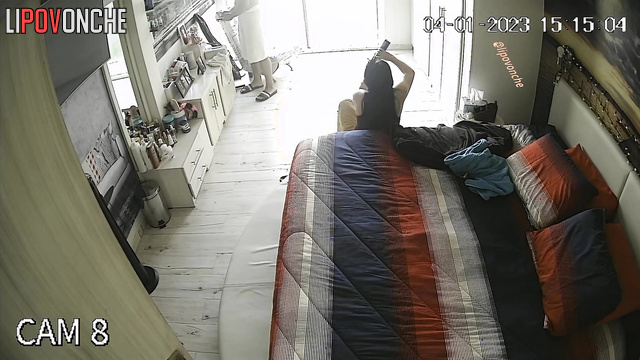 Spouses enjoying an evening of leisure in a cozy bedroom