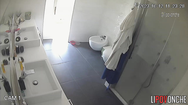 Lady staring at her shaved pubis - bathroom camera
