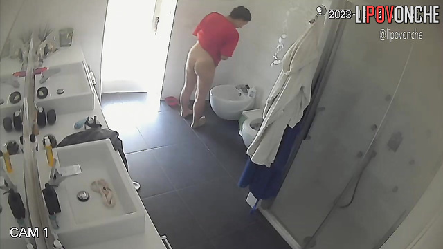 Lady staring at her shaved pubis - bathroom camera