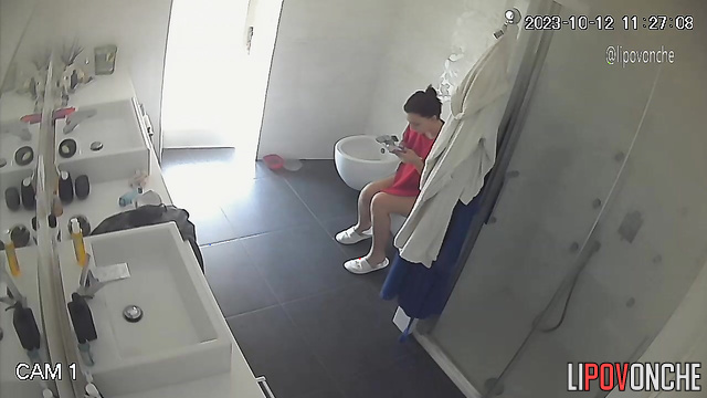 Lady staring at her shaved pubis - bathroom camera