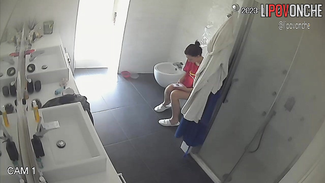 Lady staring at her shaved pubis - bathroom camera