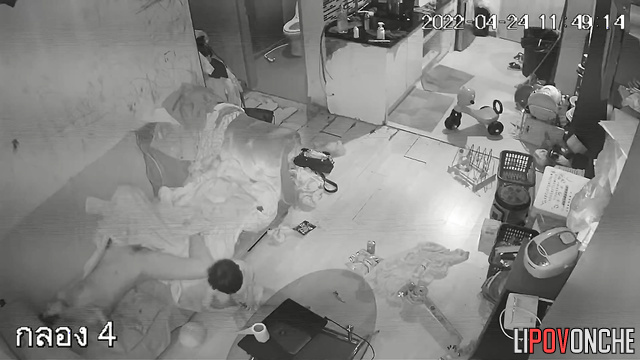 Couple walking naked through a cluttered apartment
