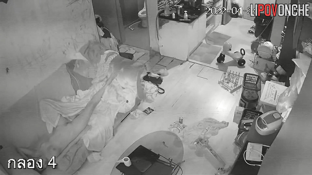 Couple walking naked through a cluttered apartment