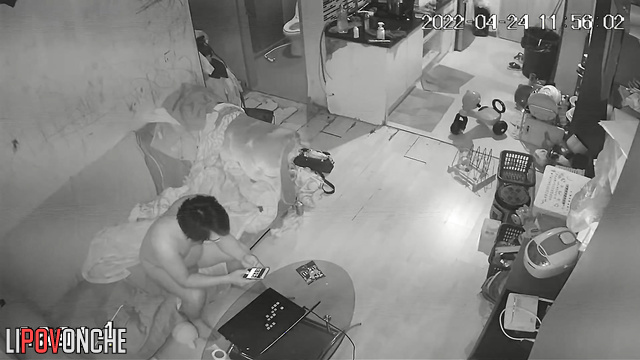 Couple walking naked through a cluttered apartment