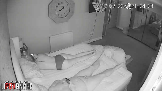 Married couple watching memes together on the bed