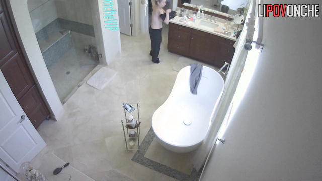 Rich lady with beautiful brests gets ready in a big bathroom