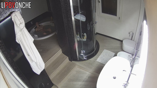 A bored naked blonde takes a hot bath in a jacuzzi before peeing