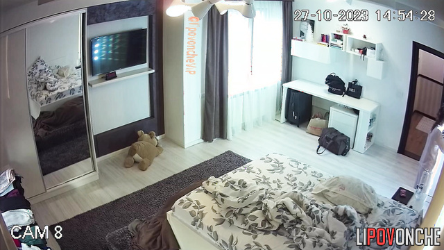 A young student with small tits walks around naked, choosing clothes for a walk