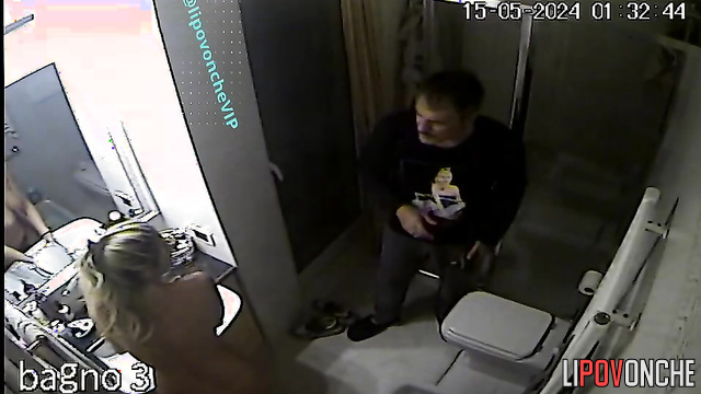 Mature blonde is not shy about peeing while her husband is in the toilet
