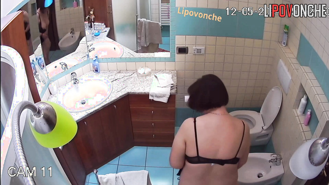 Chubby milf with a big naked ass washes her hot pussy in a bidet