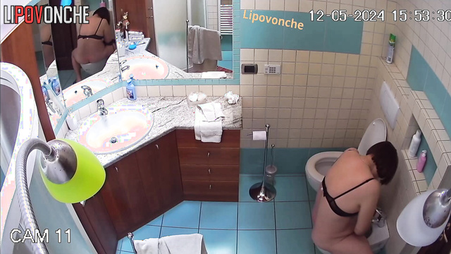 Chubby milf with a big naked ass washes her hot pussy in a bidet