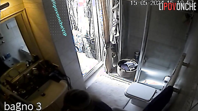 A mature blonde admires her sexy body in the mirror after peeing