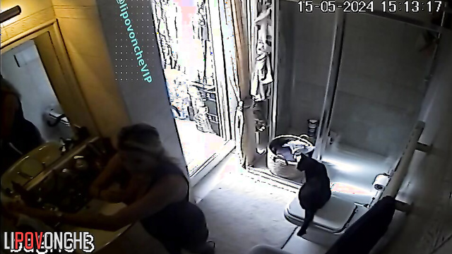 A mature blonde admires her sexy body in the mirror after peeing
