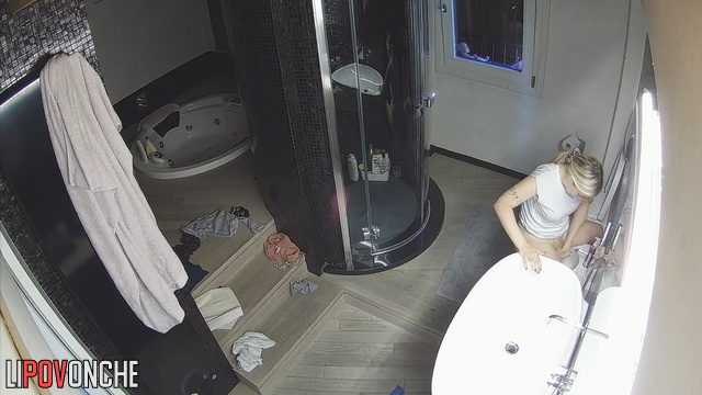 A cute blonde without panties talks to her husband while peeing