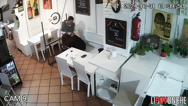 An elderly man slaps the buttocks of a young woman who is performing oral sex on him