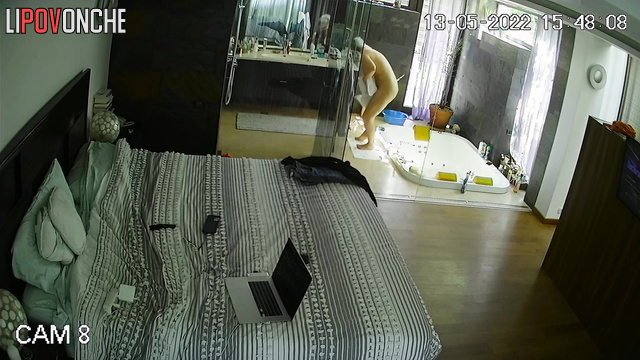 A seductive milf with a gorgeous body directs the shower jets onto her shaved pussy