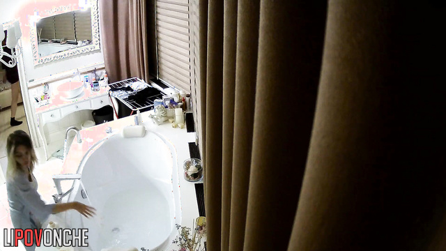 A seductive girl gives an older man a blowjob without leaving the bathtub.