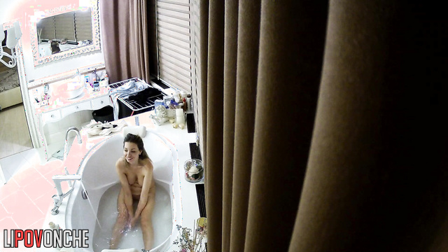 A seductive girl gives an older man a blowjob without leaving the bathtub.