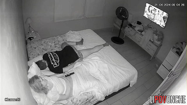 A bored housewife slips her hand under her panties while her husband snores