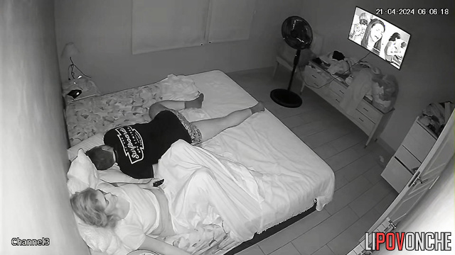A bored housewife slips her hand under her panties while her husband snores