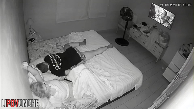 A bored housewife slips her hand under her panties while her husband snores