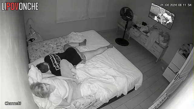 A bored housewife slips her hand under her panties while her husband snores