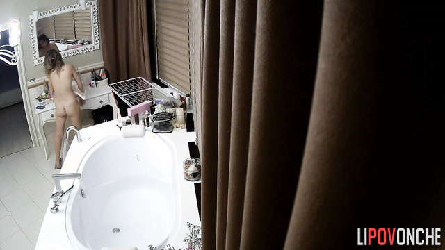 A stunning beauty completely undresses before weighing herself and taking a bath