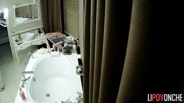 A stunning beauty dances before undressing and taking a bath