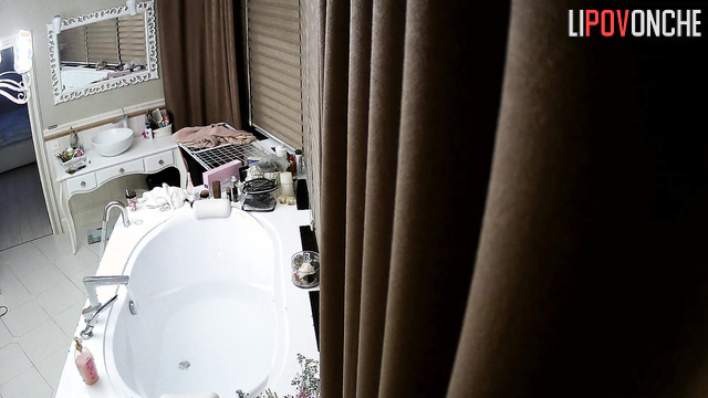 A stunning beauty dances before undressing and taking a bath