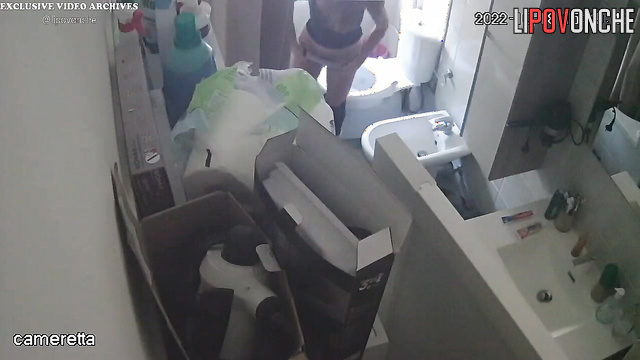 A slim, cute girl takes off her tight jeans and pees in the toilet